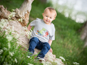 Toddler modelling a gorgeous 2nd birthday shirt, dinosaur themed