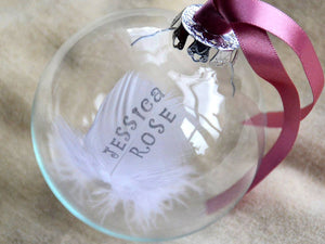 Hand stamped feather in a glass bauble